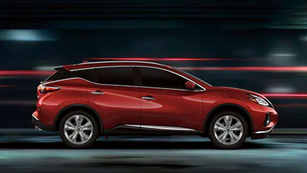2023 Nissan Murano shown in profile driving down a street at night illustrating performance. | Cronic Nissan in Griffin GA